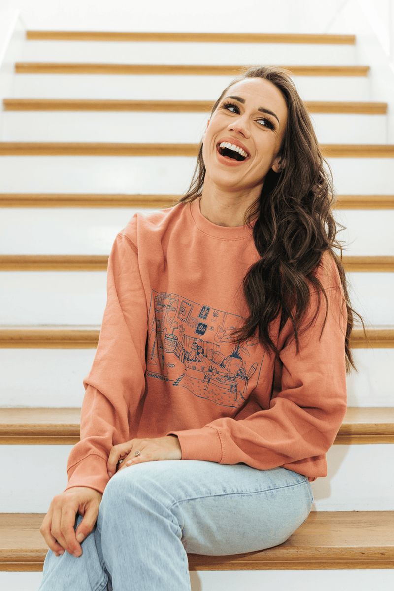 http://fanjoy.co/cdn/shop/products/colleen-ballinger-merch-colleen-ballinger-relax-podcast-room-dusty-pink-crewneck-crewneck-29472210813037_1200x1200.png?v=1660931703